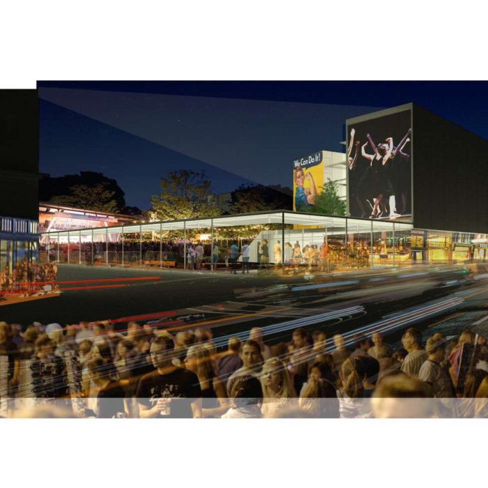 Outdoor entertainment and dining area with media screen at the 12th and Macdonald project